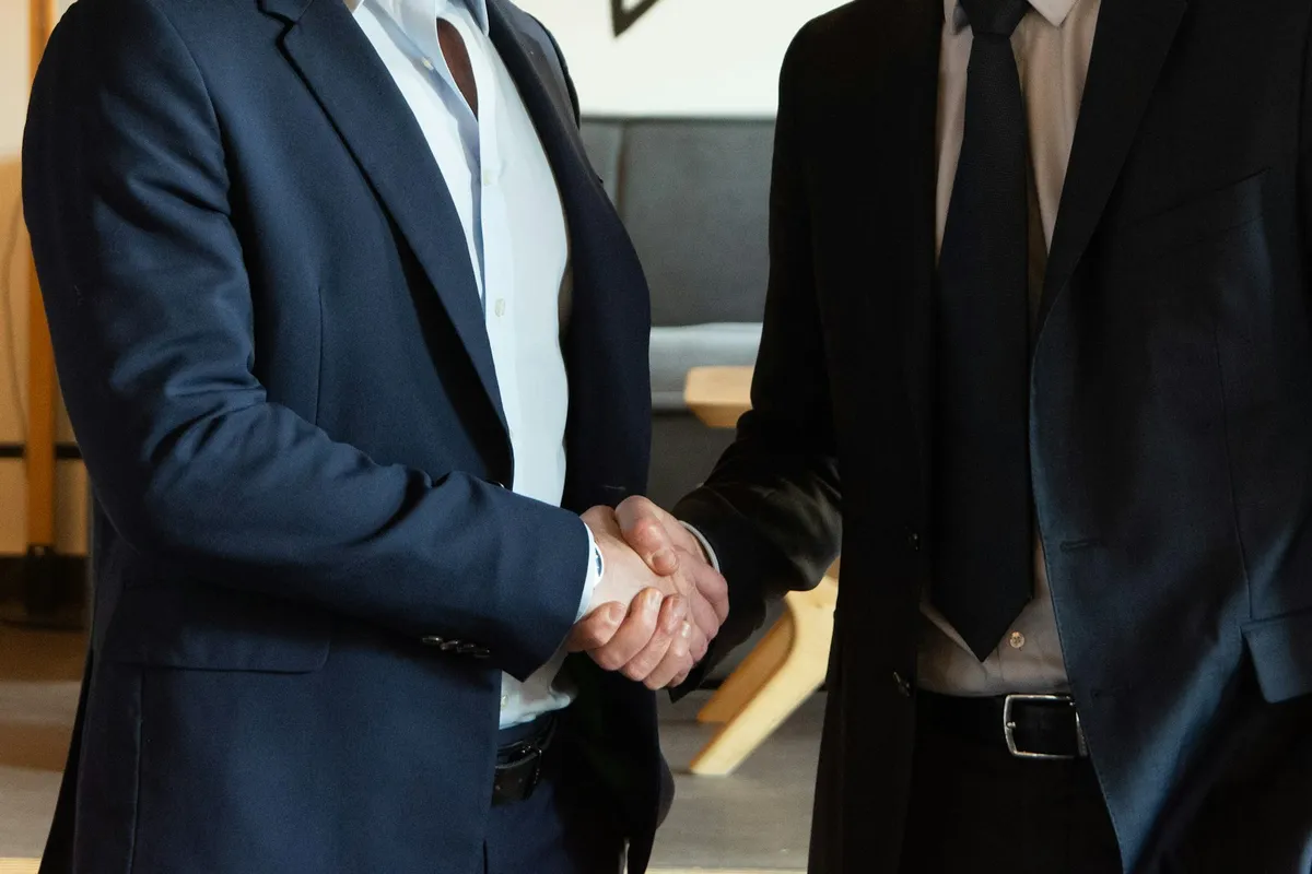 A partnership handshake between Select Talent and a client